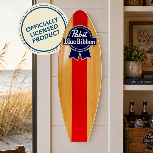 Officially licensed Pabst Blue Ribbon surfboard wall plaque featuring the iconic PBR logo on a natural wood-look MDF surfboard, perfect for home bars, man caves, garages, beach houses, and coastal décor.