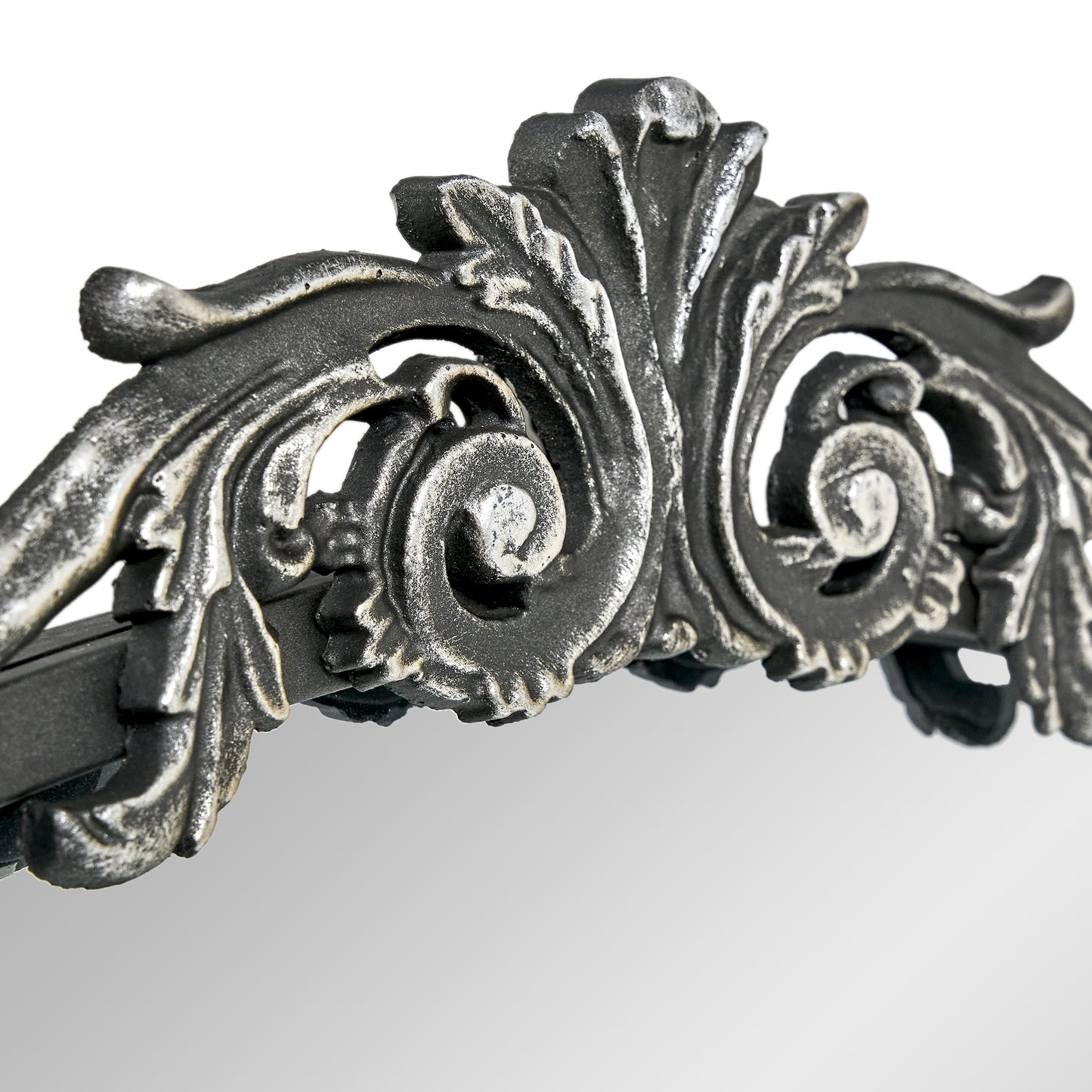 A 20 x 30 pewter arched vanity mirror with antique silver filigree crest and beaded edge, mounted vertically above a compact dresser in a bright neutral room.
