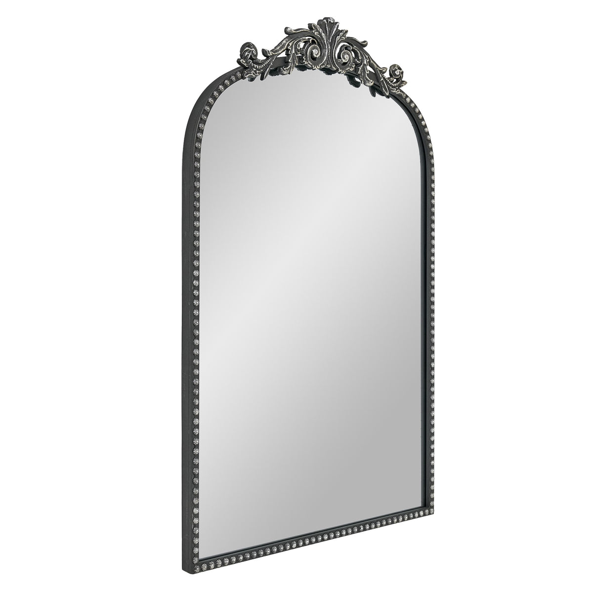 A 20 x 30 pewter arched vanity mirror with antique silver filigree crest and beaded edge, mounted vertically above a compact dresser in a bright neutral room.