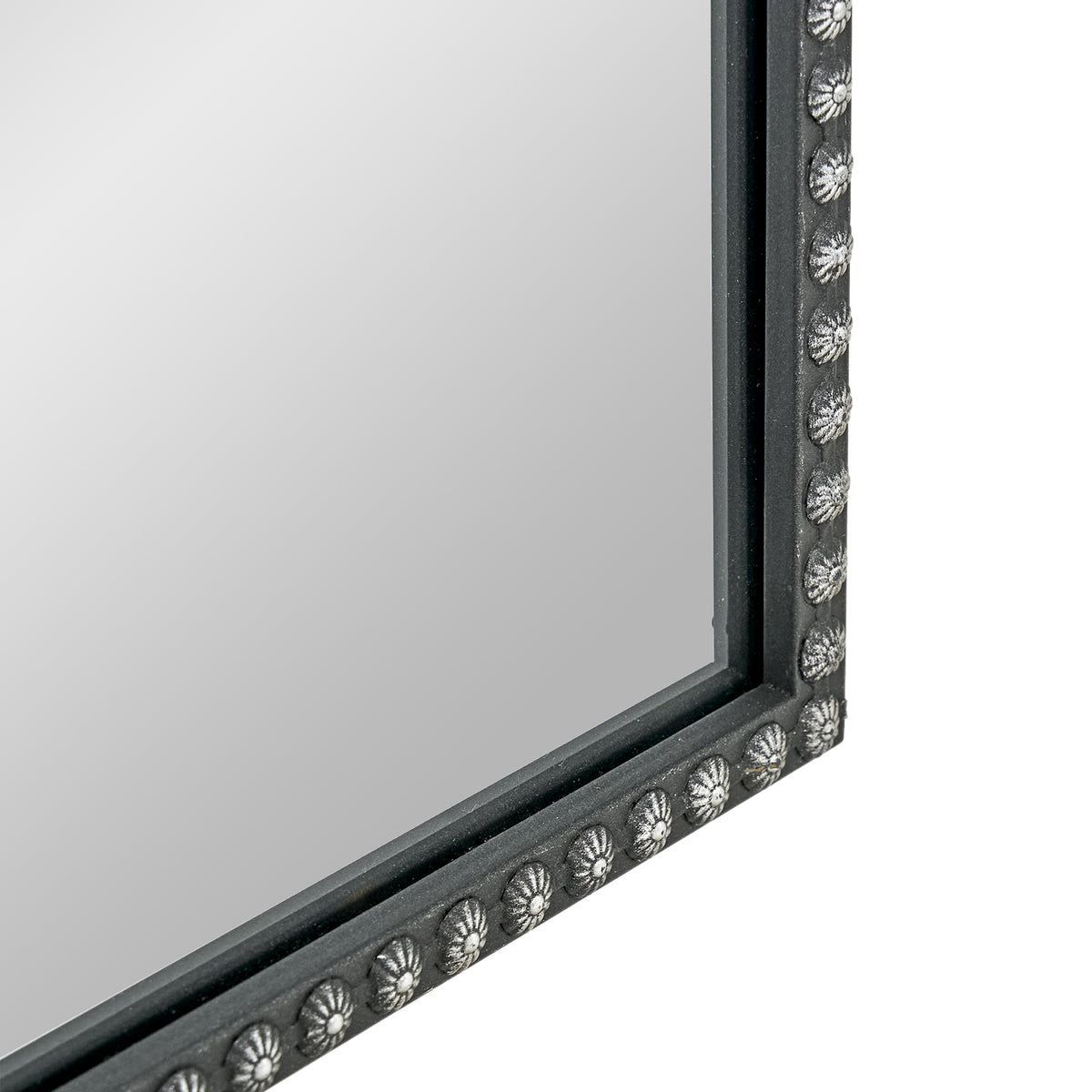 A 20 x 30 pewter arched vanity mirror with antique silver filigree crest and beaded edge, mounted vertically above a compact dresser in a bright neutral room.
