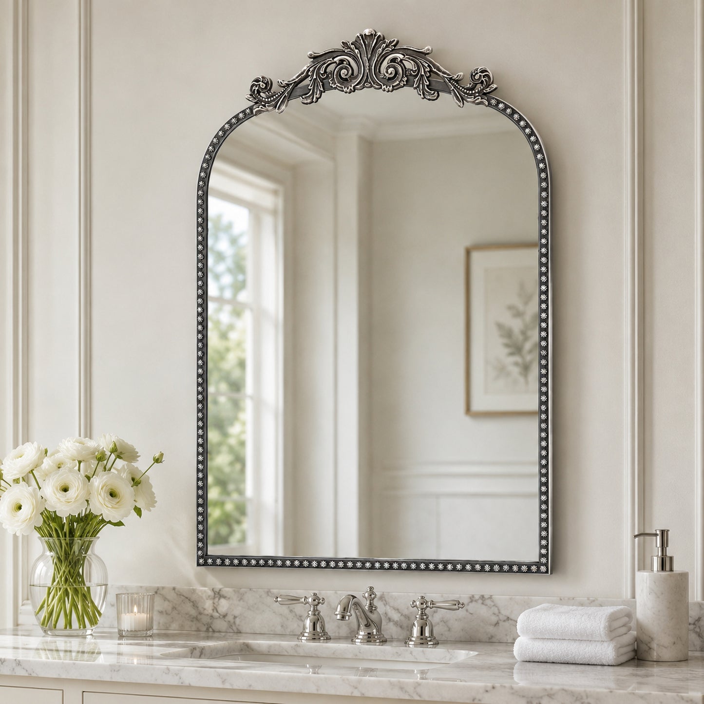A 20 x 30 pewter arched vanity mirror with antique silver filigree crest and beaded edge, mounted vertically above a compact dresser in a bright neutral room.