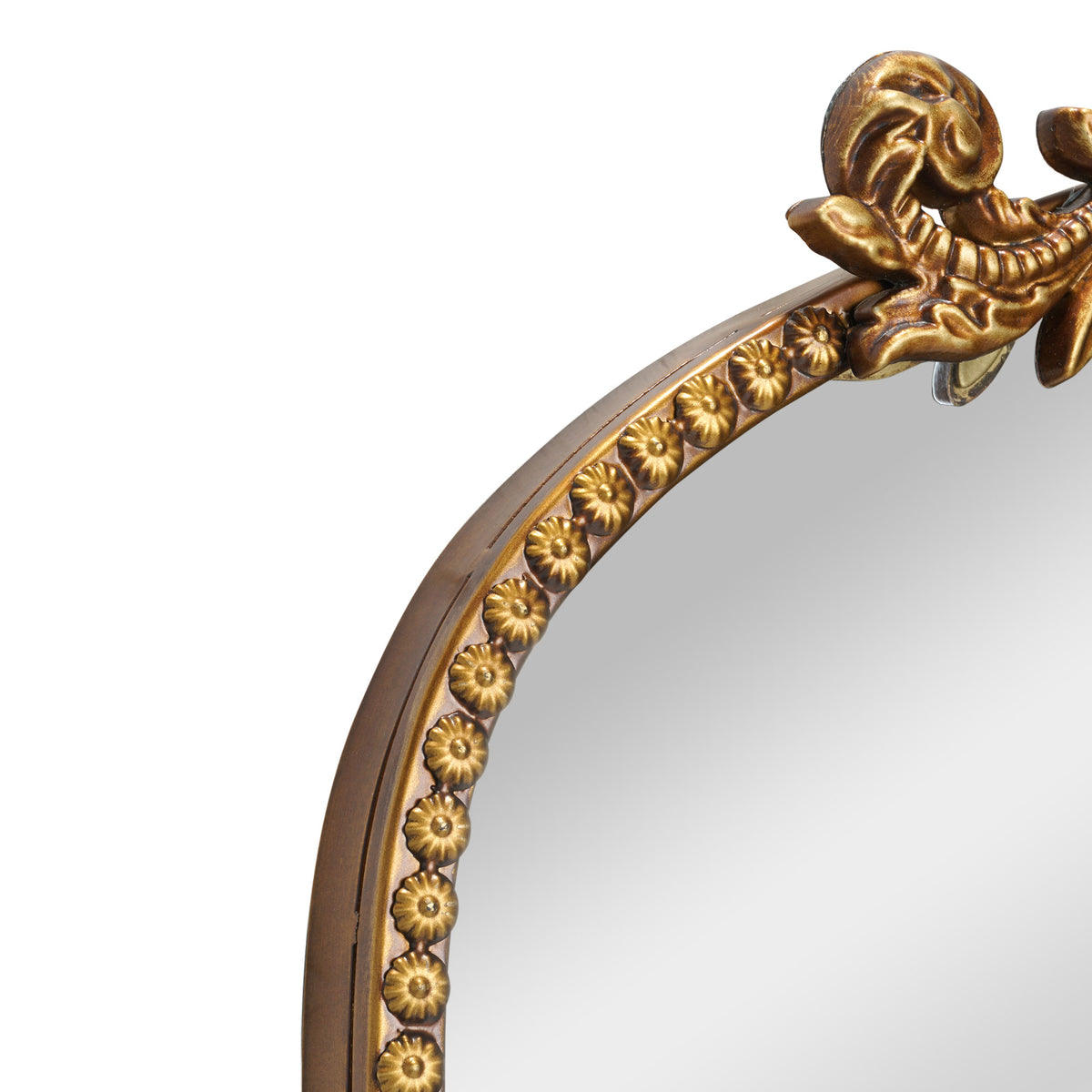 A compact 20 x 30 antique gold arched wall mirror with filigree crest and beaded trim, displayed vertically above a vanity for grooming in a warm dressing space.