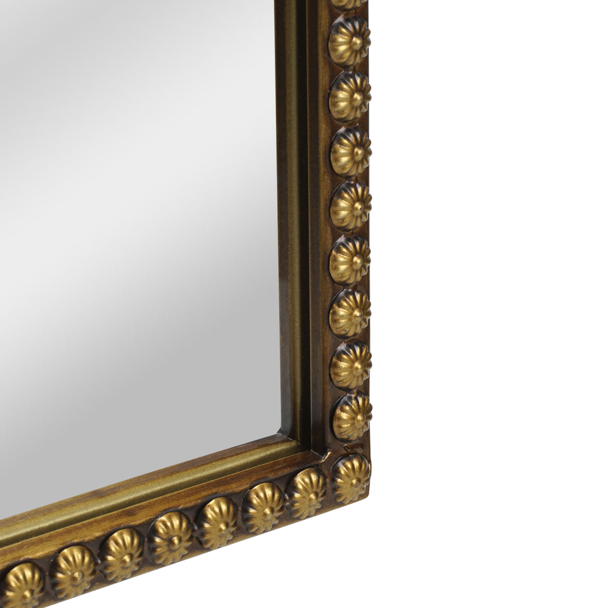A compact 20 x 30 antique gold arched wall mirror with filigree crest and beaded trim, displayed vertically above a vanity for grooming in a warm dressing space.