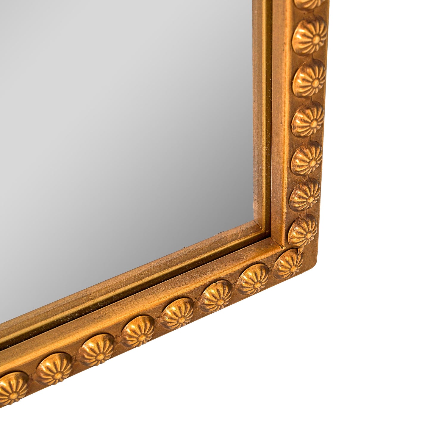 A slim 22 x 64 antique gold arched full body mirror with ornate filigree crest and floral-bead border, leaning beside a dresser and closet in a warm bedroom.