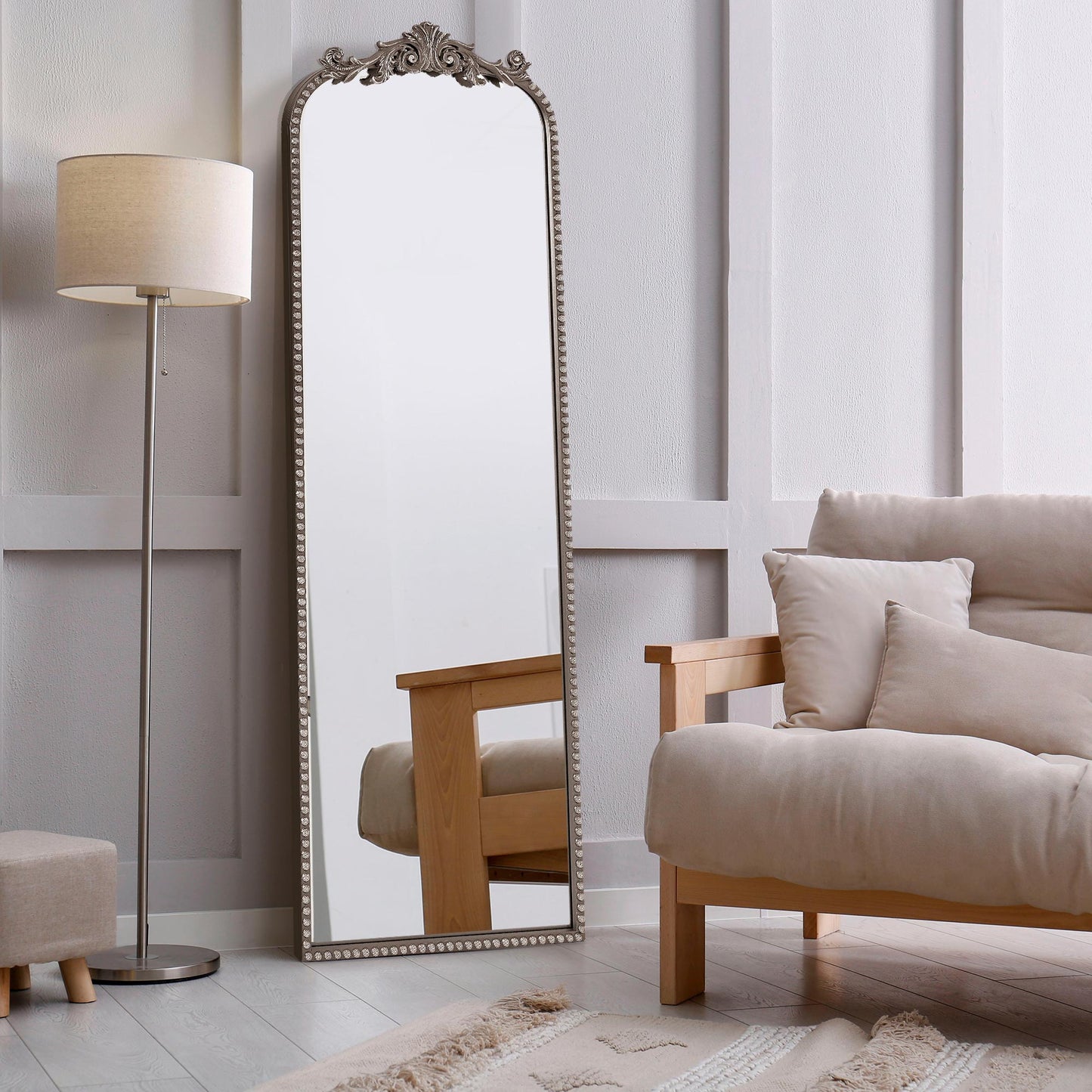 A 22 x 64 pewter arched full length mirror with antique silver scrollwork and beaded frame, positioned as a narrow floor leaner near a closet and entry area.