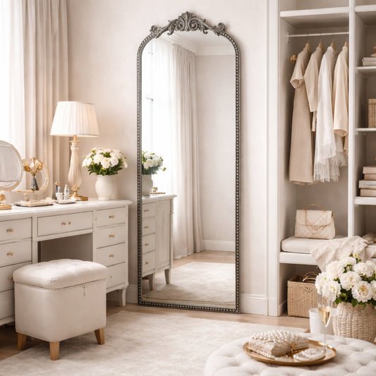 A 22 x 64 pewter arched full length mirror with antique silver scrollwork and beaded frame, positioned as a narrow floor leaner near a closet and entry area.