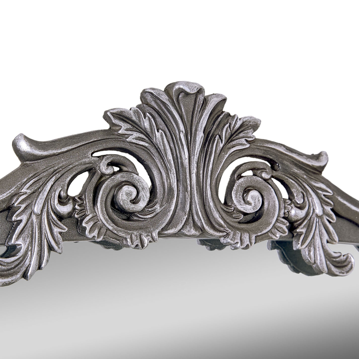 A 24 x 34 pewter arched wall mirror with antique silver filigree crest and beaded trim, displayed horizontally above a vanity or console in a polished neutral interior.