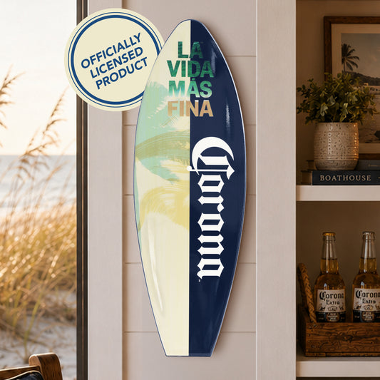 Officially licensed Corona surfboard wall plaque featuring La Vida Más Fina artwork with palm trees and tropical beach colors on a wood-look MDF surfboard for coastal homes, patios, and home bars.