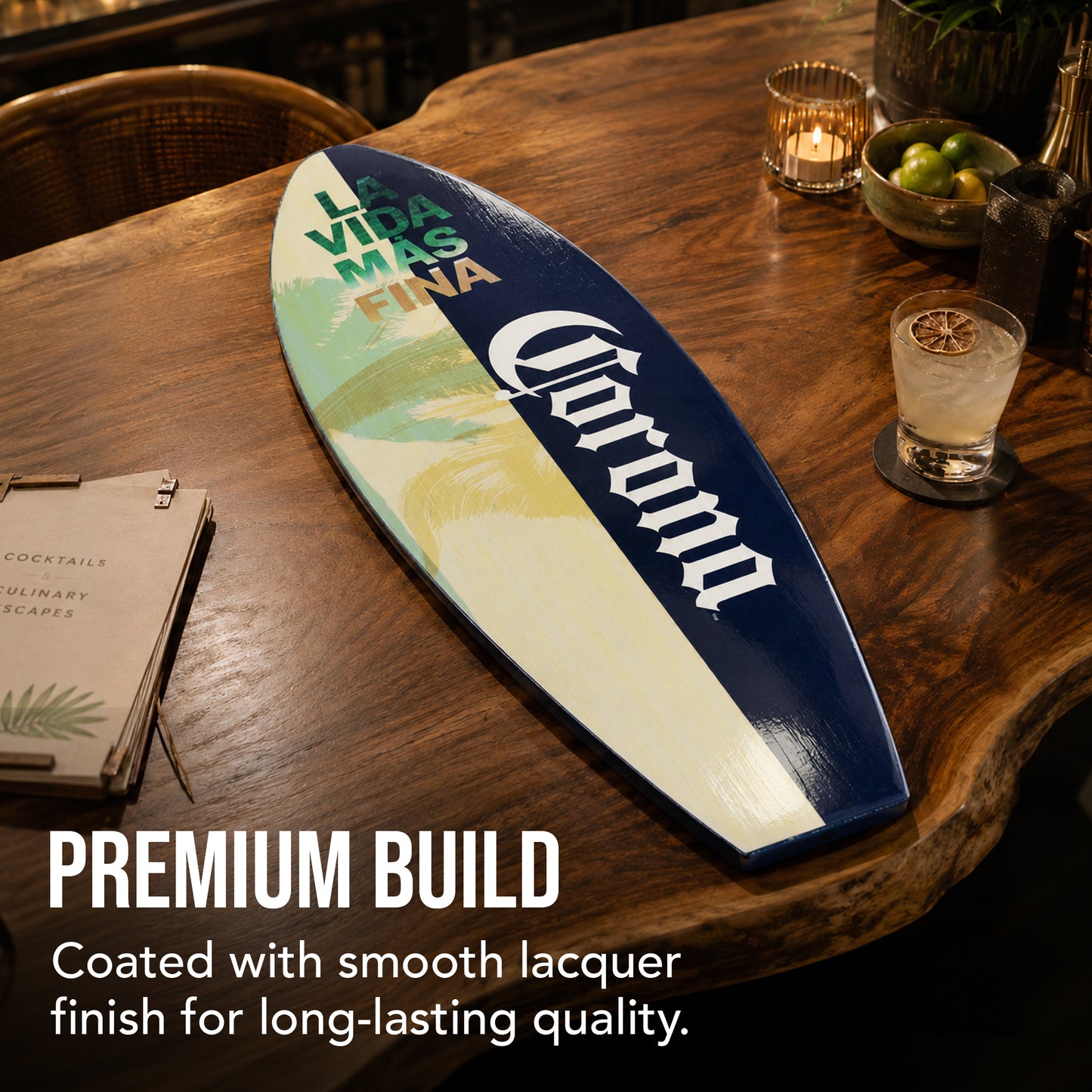 Officially licensed Corona surfboard wall plaque featuring La Vida Más Fina artwork with palm trees and tropical beach colors on a wood-look MDF surfboard for coastal homes, patios, and home bars.